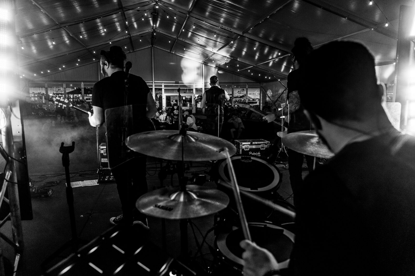 Patrick & the LVB performing live, shot from behind the drum kit